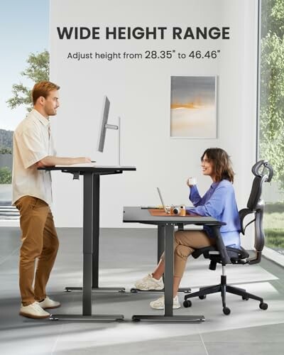 Two people working at adjustable standing desks in an office setting.