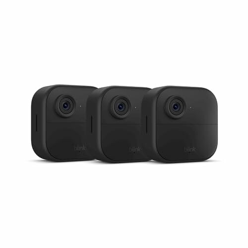 Three black Blink outdoor security cameras.