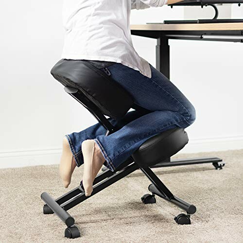 Person using ergonomic kneeling chair at desk