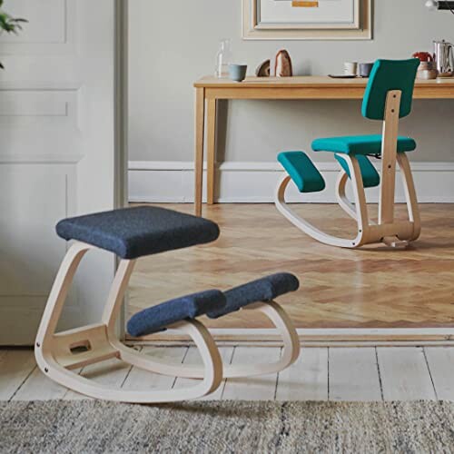 Two ergonomic kneeling chairs in a room with wooden flooring.