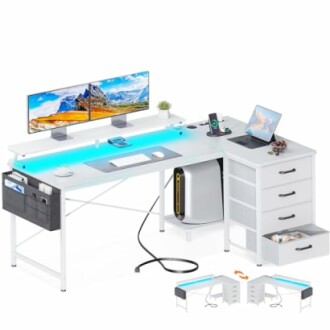 Modern L-shaped desk with dual monitors, laptop, and storage drawers.