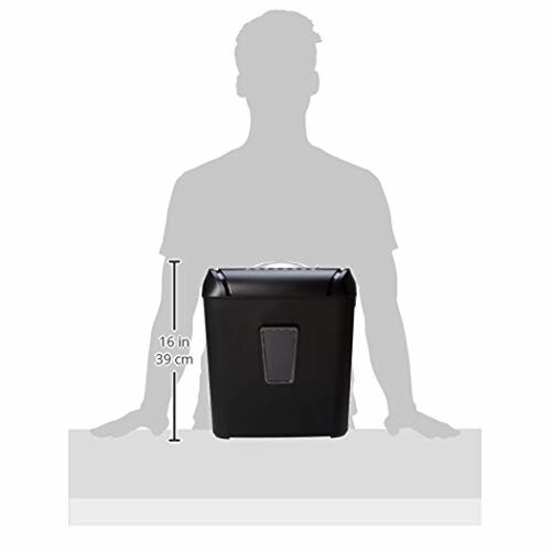 Paper shredder with size comparison against silhouetted person.