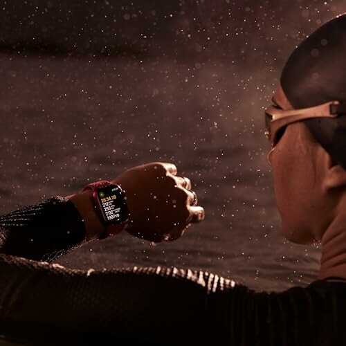 Swimmer checking smartwatch in water